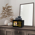 Load image into Gallery viewer, LovfurBlack pet urn on a wooden table with a photo frame and decorative elements.